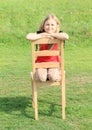 Girl kneeing on chair
