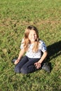 Girl kneeing on grass