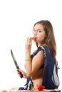 Girl with a knife eat tomato Royalty Free Stock Photo