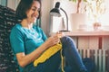 Girl knits crochet at home.