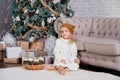 girl in knitted hat near christmas tree makes a wish for new year Royalty Free Stock Photo