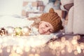 girl in knitted hat near christmas tree makes a wish for new year Royalty Free Stock Photo