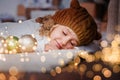 girl in knitted hat near christmas tree makes a wish for new year Royalty Free Stock Photo