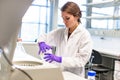 Girl in laboratory prepares centrifuge for work