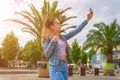 Girl lake summer. Happy young girl with phone smile, typing texting and taking selfie in summer sunshine urban city. Pretty female Royalty Free Stock Photo