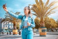 Girl lake summer. Happy young girl with phone smile, typing texting and taking selfie in summer sunshine urban city. Pretty female Royalty Free Stock Photo