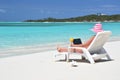 Girl with a laptop on the beach. Exuma, Bahamas Royalty Free Stock Photo