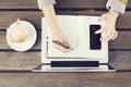 Girl with laptop, blank diary, cell phone and coffee mug on wood Royalty Free Stock Photo