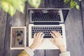 Girl with laptop, cell phone and diary on wooden table outdoor