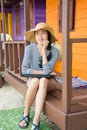 Girl with laptop in front of a beach house Royalty Free Stock Photo