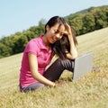 Girl on Laptop in Meadow