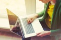 Girl with laptop near window