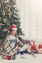 Young woman online on laptop at christmas interior Royalty Free Stock Photo