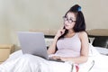 Girl with laptop thinking idea on bed Royalty Free Stock Photo