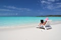 Girl with a laptop on the tropical beach