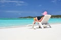 Girl with a laptop on the tropical beach