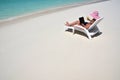 Girl with a laptop on the tropical beach Royalty Free Stock Photo