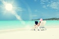 Girl with a laptop on the tropical beach