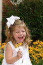 Girl laughing and holding flower