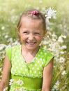 Girl laughs among daisy flowers. Smiling girl on a field of dais