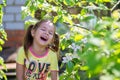 The girl laughs standing near the blossoming tree Royalty Free Stock Photo