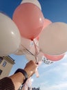 A girl launches balloons into the sky