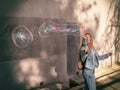 Girl launches beautiful soap bubbles on the street