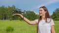 The girl launches a drone from her hand in the park. Royalty Free Stock Photo