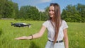 The girl launches a drone from her hand in the park. Royalty Free Stock Photo