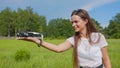 The girl launches a drone from her hand in the park. Royalty Free Stock Photo