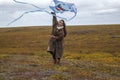 Girl launches a kite in the tundra for the first time in her life Royalty Free Stock Photo