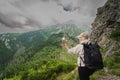 The girl launches a mini drone in the mountains in summer