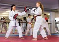 Girl launching blows on focus punch mitts