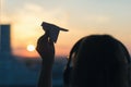 A girl is launching a paper airplane from a window at sunset. Royalty Free Stock Photo