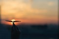 A girl is launching a paper airplane from a window at sunset. Royalty Free Stock Photo