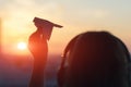 A girl is launching a paper airplane from a window at sunset. Support of the Telegram application and freedom internet. Royalty Free Stock Photo