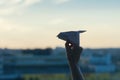 A girl is launching a paper airplane from a window at sunset. Support of the Telegram application and freedom internet. Royalty Free Stock Photo