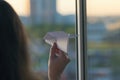 A girl is launching a paper airplane from a window at sunset. Support of the Telegram application and freedom internet. Royalty Free Stock Photo