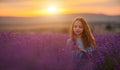 Girl lavender sunset. Girl in blue dress with flowing hair walk on the lavender field.