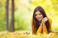 Girl laying on autumn leafs