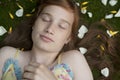 Girl Laying on Petals Eyes Closed Royalty Free Stock Photo