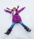 Girl laying in star shape in snow Royalty Free Stock Photo