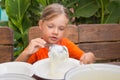 The girl lays on breakfast porridge