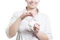 Girl lays coin in piggy bank. Collect and keep money at home. Piggy bank and coins concept. Woman with piggy bank and coin