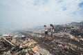 Girl leading her friend through the smoke at garbage dump Royalty Free Stock Photo