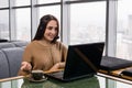 Girl leads some online broadcast from the coffee shop and talks with listeners