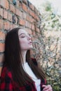 Girl leaned against a brick wall, portrait of a cute girl