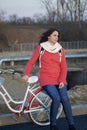 The girl leans on a parked bike. Rest on the spring cycle Royalty Free Stock Photo