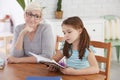 Girl learning reading with tutor