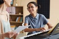 Girl learning to play piano with teacher Royalty Free Stock Photo